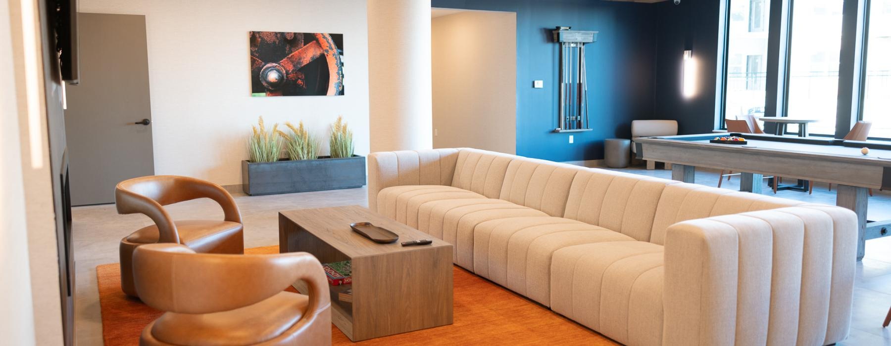 a lounge with a couch seating and a table