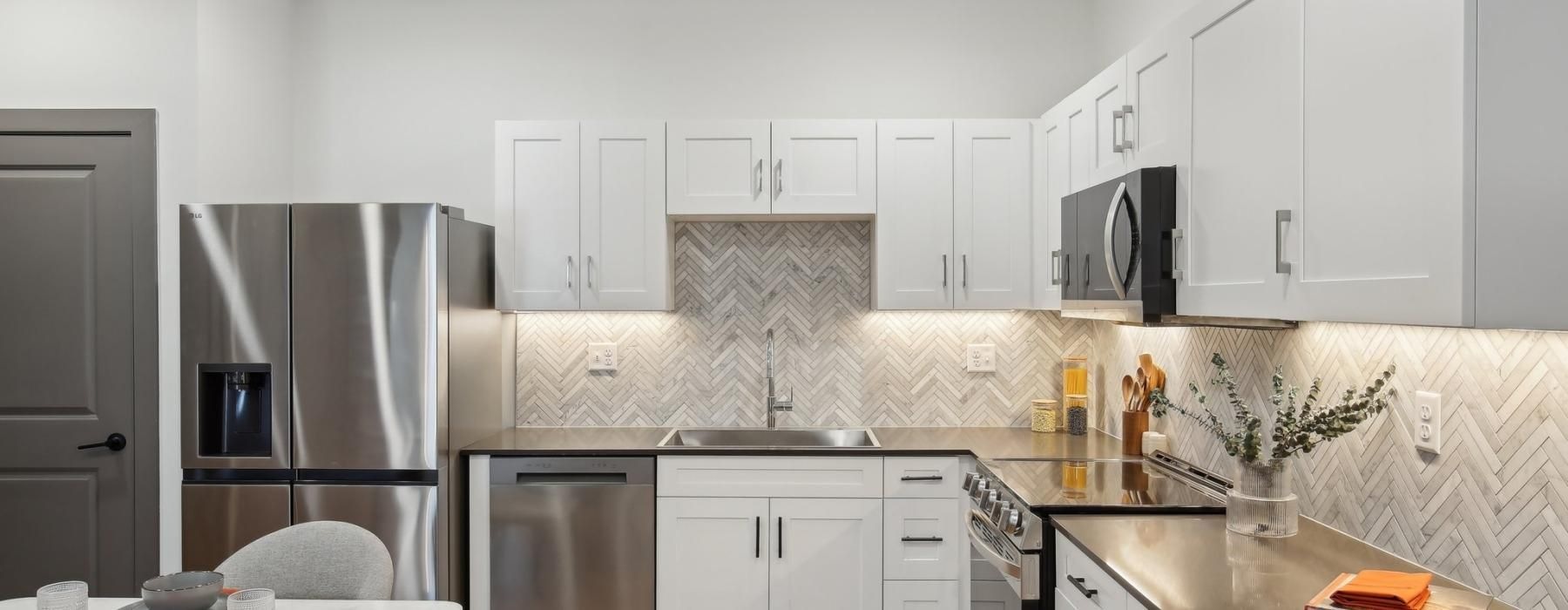 a kitchen with white cabinets