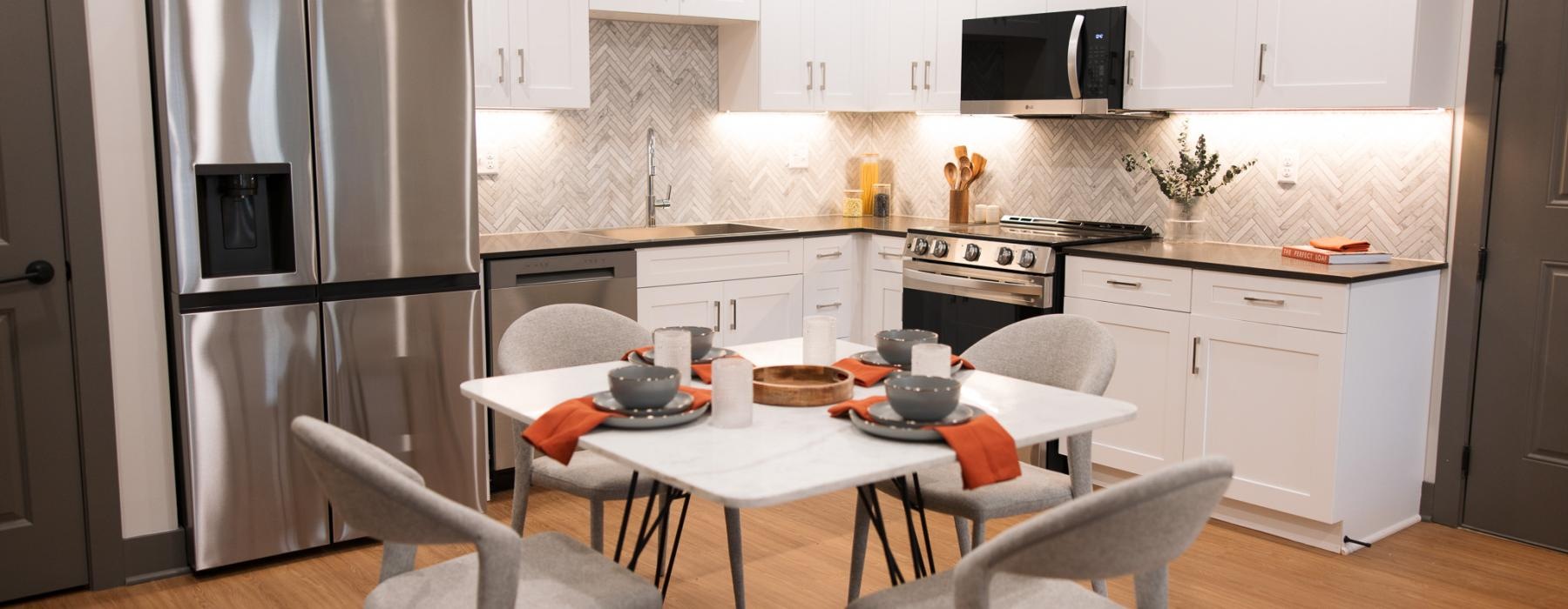 a kitchen with a table and chairs